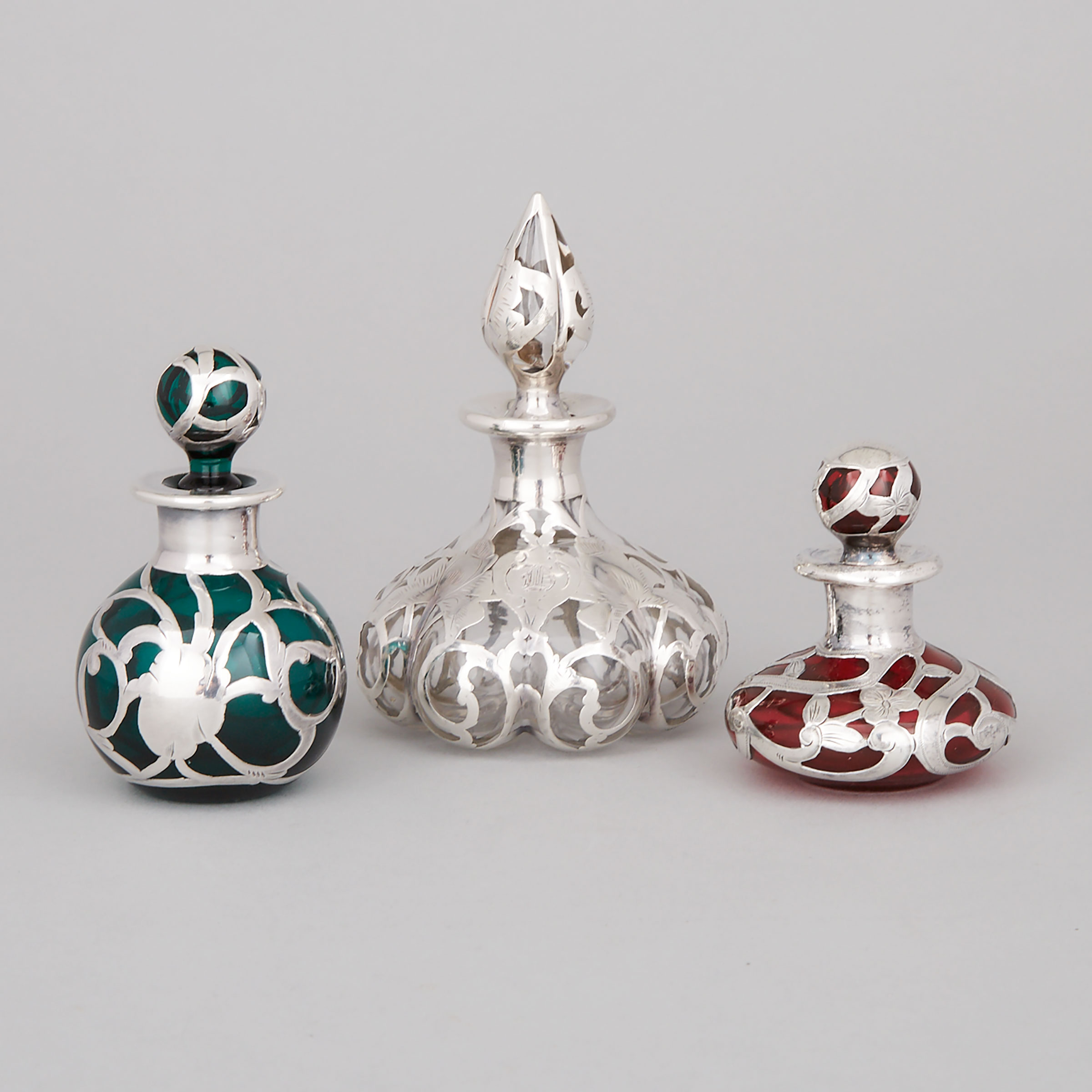 Three American Silver Overlaid Glass Perfume Bottles, early 20th century