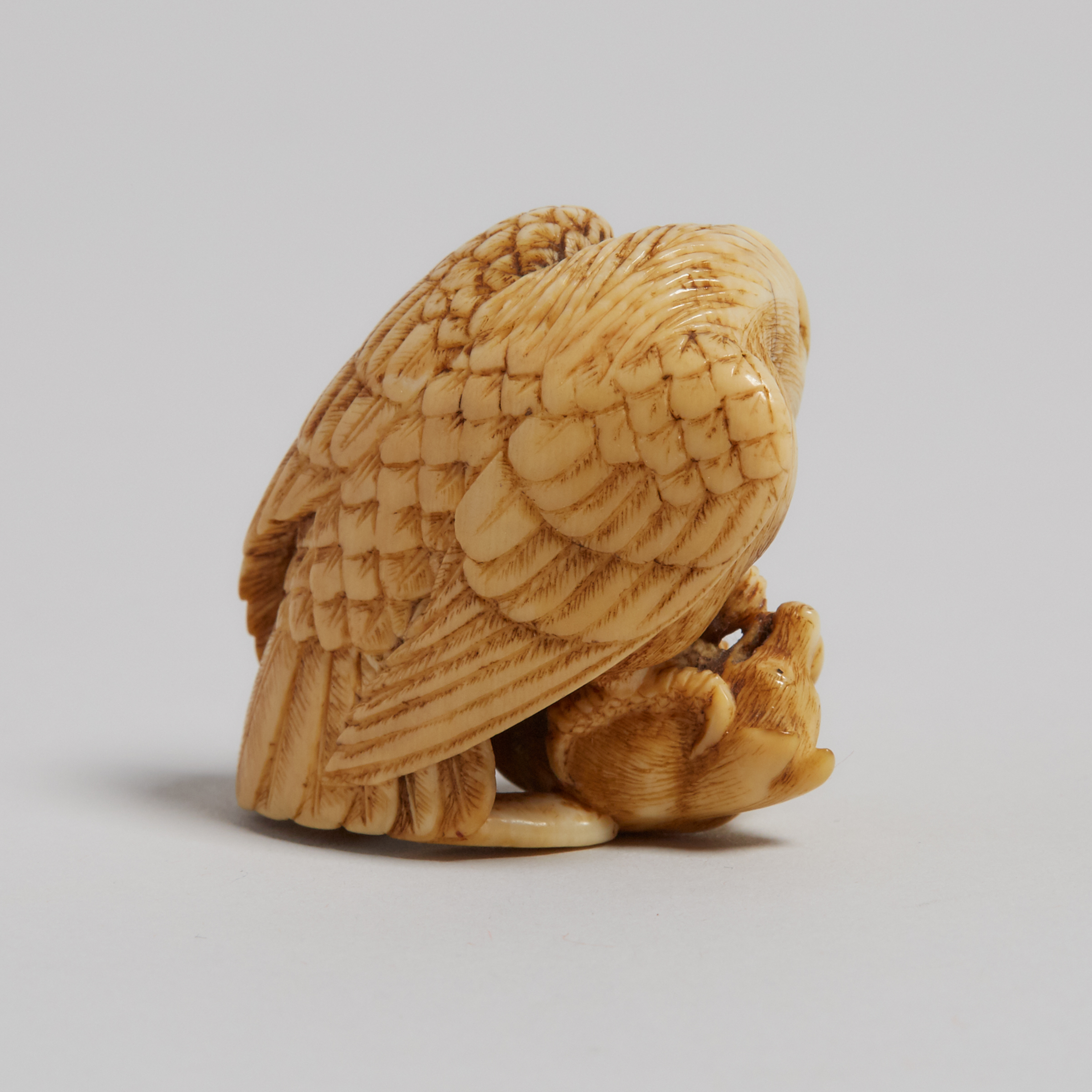 An Ivory Carved Netsuke of an Eagle and a Fox, Signed Tomochika, Late 19th Century