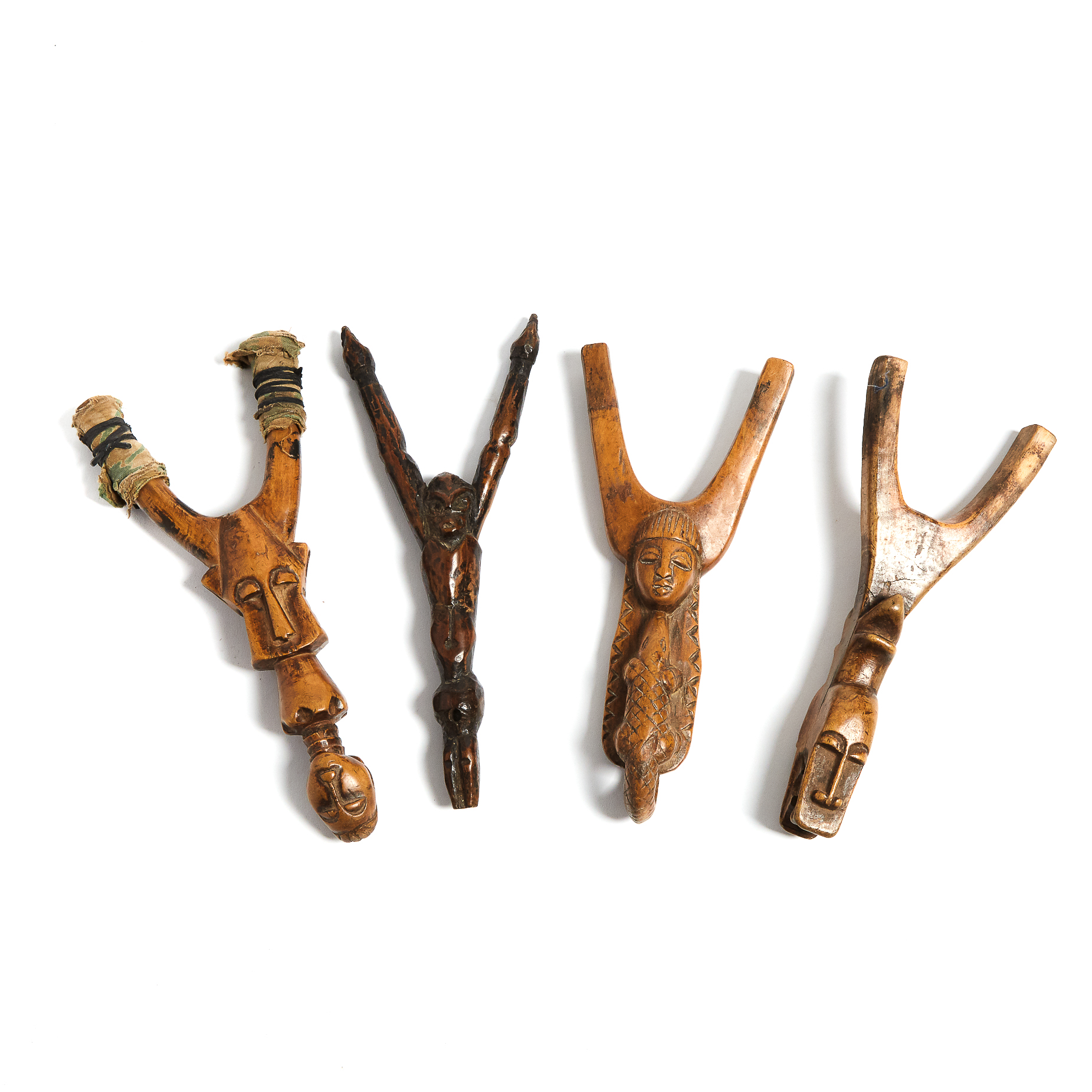 Group of Four African Carved Wood Anthropo-zoomorphic Slingshots