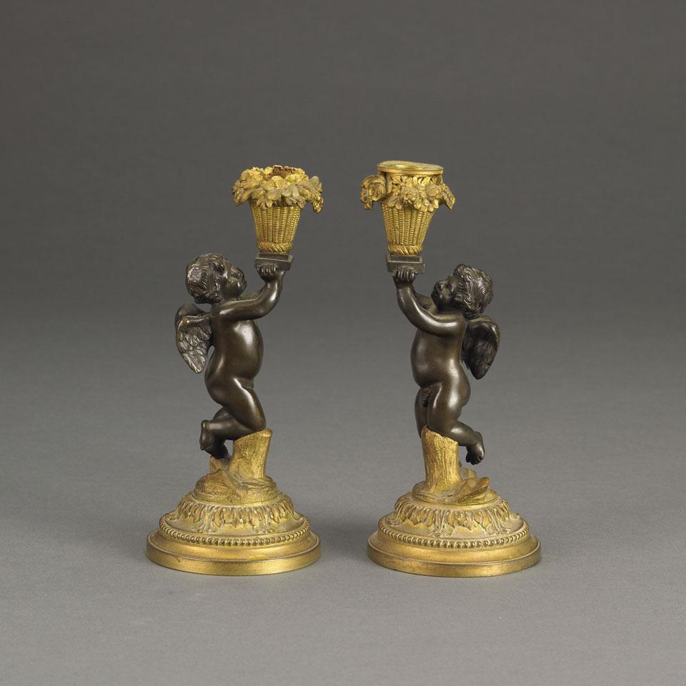 Pair of Patinated and Gilt Bronze Cherub Candlesticks, late 19th century