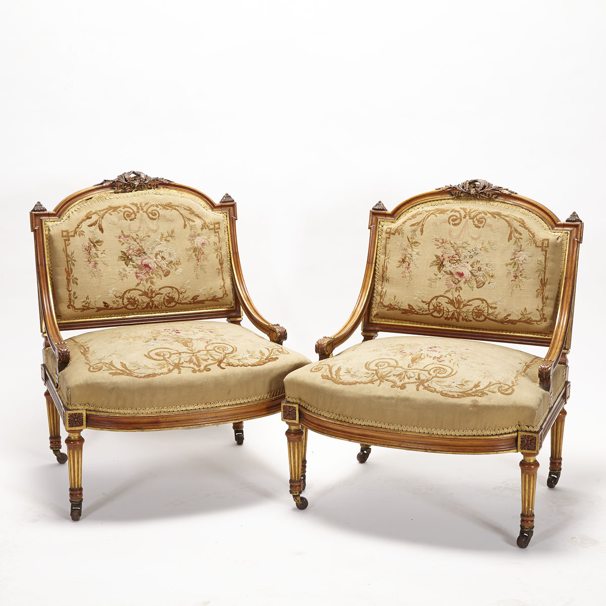 Pair of Parcel Gilt Carved Walnut Low Fauteuils, 19th century