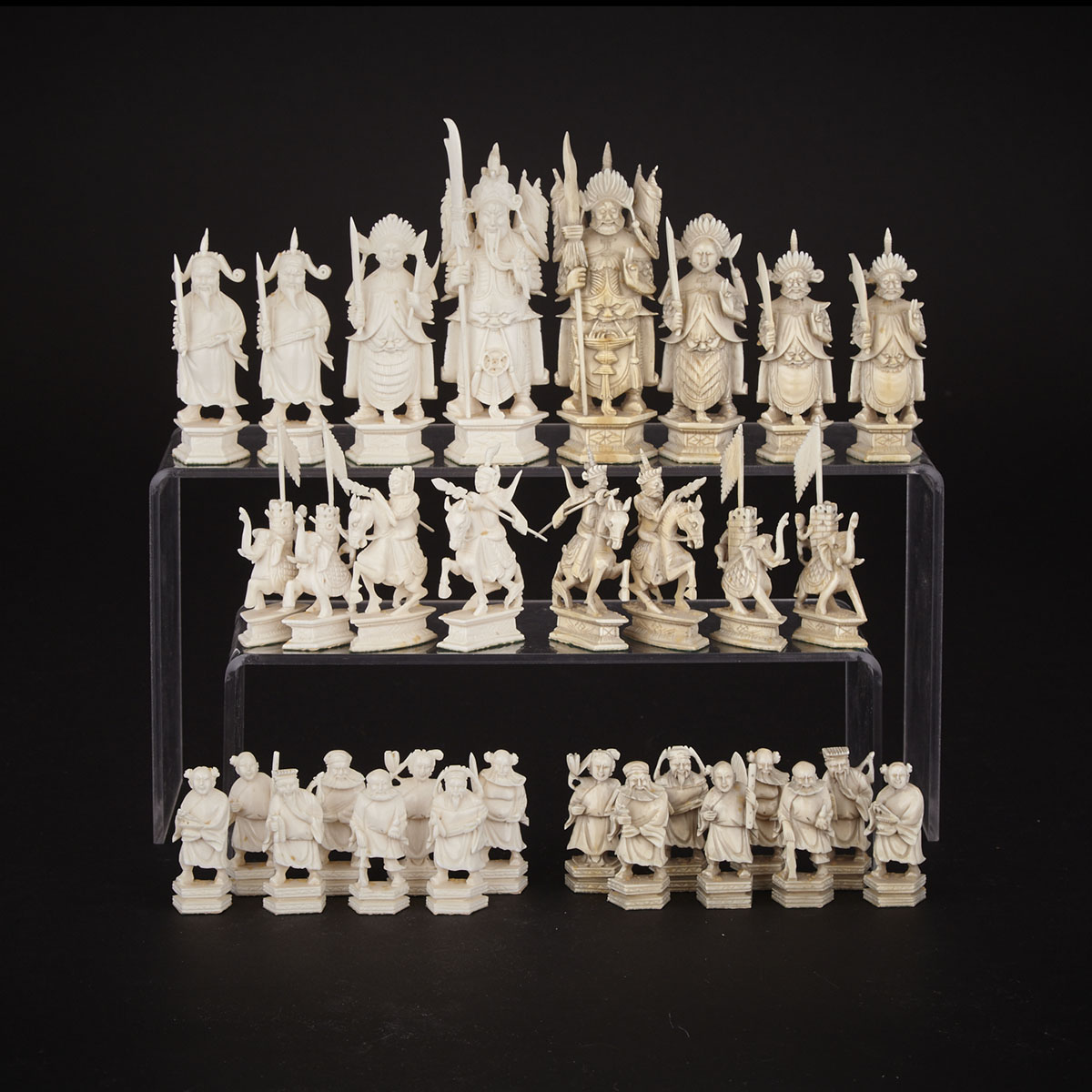  Chinese Carved Ivory ‘China vs. Mongolia’ Figural Chess Set, Canton, early 20th century
