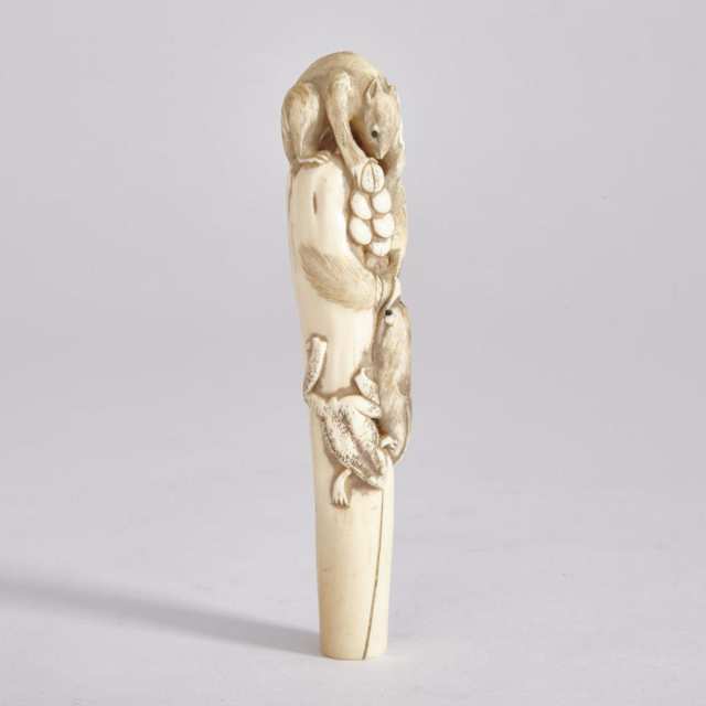 A Carved Japanese Ivory ‘Squirrels and Grapes’ Cane Handle, Meiji Period