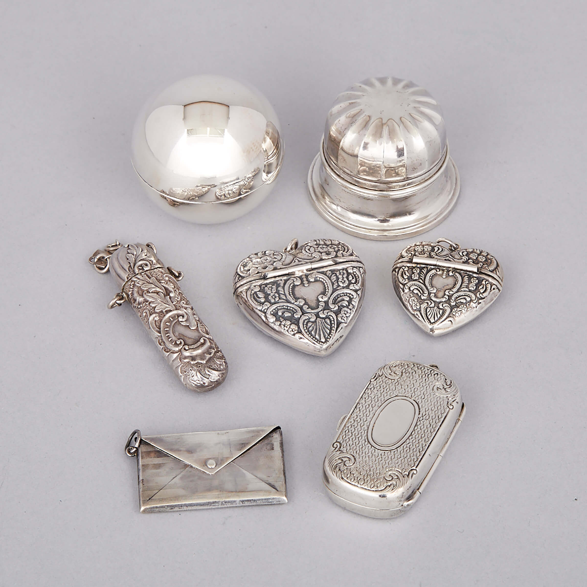Two North American Silver Heart Shaped Small Boxes, Coin Case, Stamp Case, Two Ring Boxes and a Victorian Needle Case, late 19th/20th century