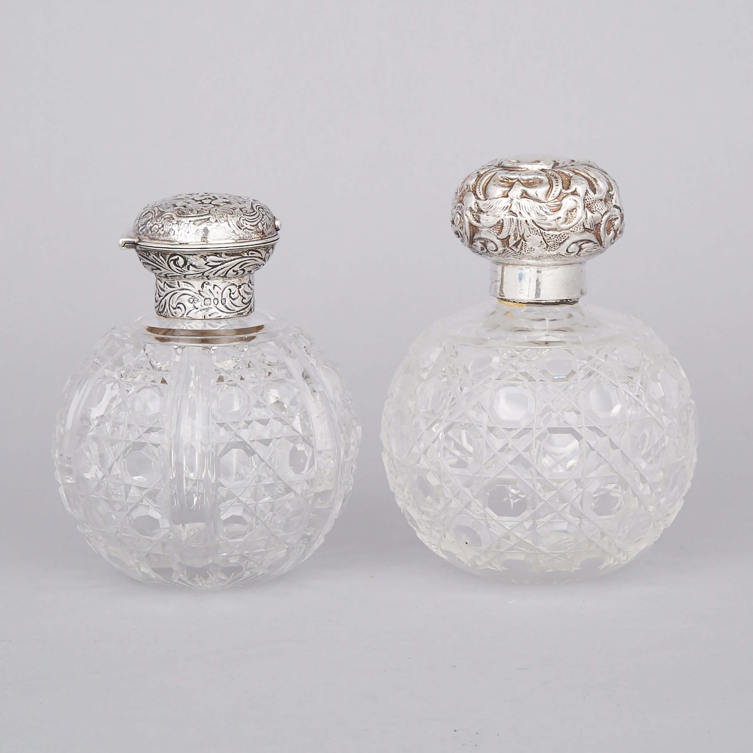 Two English Silver Mounted Cut Glass Toilet Water Bottles, William Comyns & Sons and William Neale & Sons, London and Chester, 1892/1902